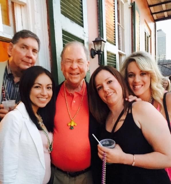 Brazos Eye team and family on a New Orleans balcony during a company outing