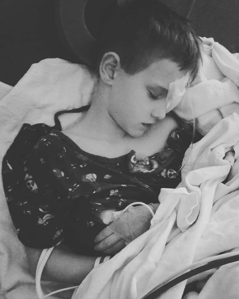 Young Branson resting in a hospital bed with a bandage over his injured eye after the accident