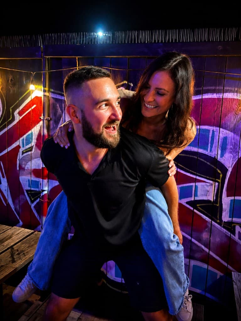 Dr. Jordan Tanous and his wife Kaitlyn laughing together on a night out